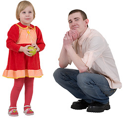 Image showing Little girl with green apple and young man