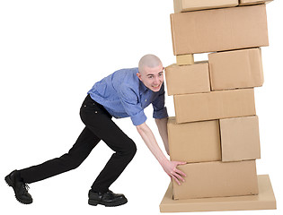 Image showing Man push pile cardboard boxes