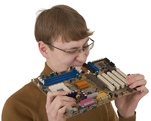 Image showing Young man bite motherboard