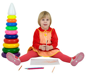 Image showing Little girl and toy pyramid and crayons