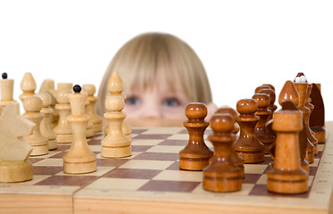 Image showing Little girl looking chess