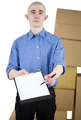 Image showing Man with tablet and carton boxes