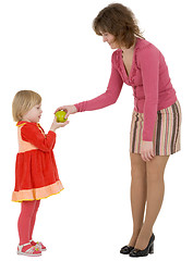 Image showing Women give apple to the girl