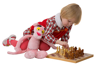 Image showing Little girl play chess