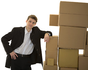 Image showing Man lean one's elbows on cardboard boxes