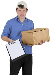 Image showing Man in baseball cap with cardboard box