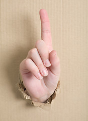 Image showing Gesture male hand through cardboard