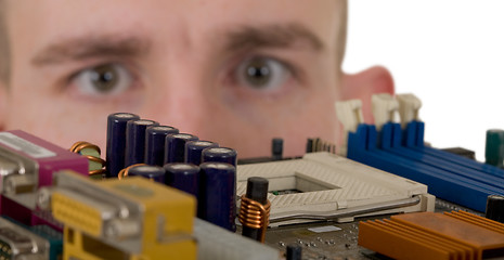 Image showing Man examines an electronic circuit