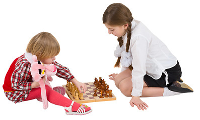 Image showing Girl teaching little girl play chess