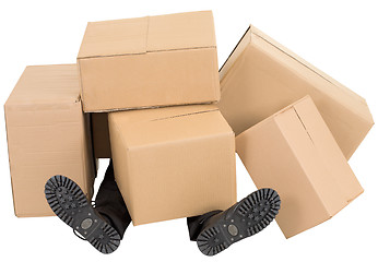 Image showing Male feet under a heap of boxes