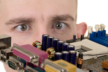 Image showing Man examines an electronic circuit