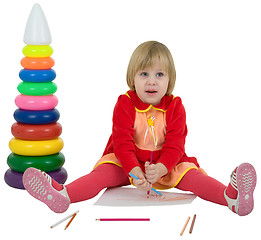 Image showing Little girl and toy pyramid and crayons