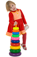 Image showing Little girl and toy plastic pyramid