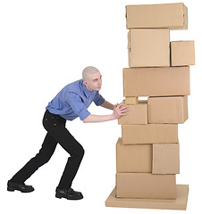 Image showing Man pushing pile cardboard boxes