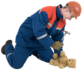 Image showing Man with hammer and toy bear