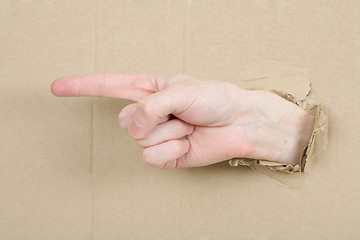 Image showing Gesture male hand through cardboard