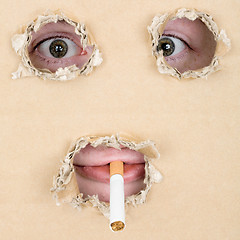 Image showing Mug smoking a cigarette