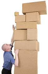 Image showing Man trying get the most upper box