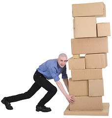 Image showing Man pushing pile from cardboard boxes