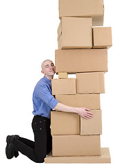 Image showing Postman embrace cardboard boxes