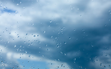 Image showing Rain drops on glass and the sky