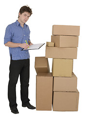 Image showing Man with marker and pile cardboard boxes