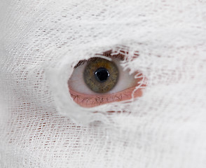 Image showing Eye looking on hole in bandage