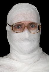 Image showing Guy rolled up by bandage in spectacles