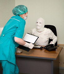 Image showing Patient similar to a mummy and the doctor