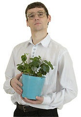 Image showing Man in spectacles with window plant in flowerpot