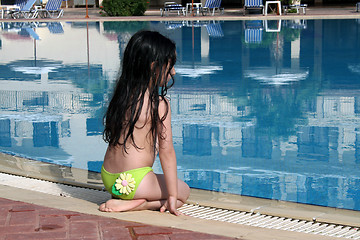 Image showing Girl sitting by the pool