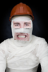 Image showing Guy in bandage with the helmet and false face