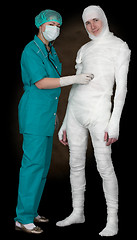 Image showing Man in bandage and nurse with stethoscope