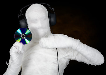 Image showing DJ costume mummy with ear-phones and disc