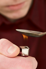 Image showing Tea-spoon and lighter