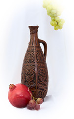 Image showing Still-life with a bottle and pomegranate