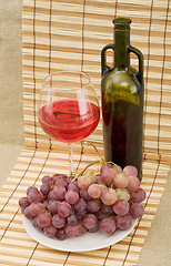 Image showing Grapes and wine on mat