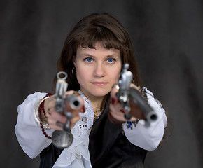 Image showing Girl - pirate with two ancient pistols in hands