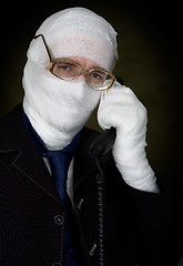 Image showing Man in bandage calling on phone