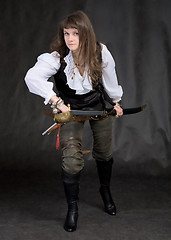 Image showing The girl - pirate with a sabre in hands