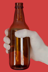 Image showing Brown bottle on hand