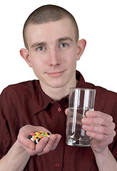 Image showing Boy with tablets and glass of water