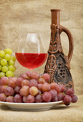 Image showing Ceramic bottle, grapes and red wine