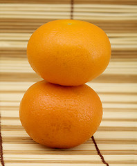 Image showing Two ripe mandarins on mat