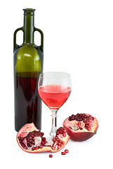 Image showing Glass of wine, bottle and a red pomegranate