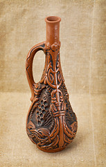 Image showing Ceramic bottle on textile background