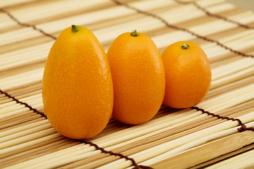 Image showing Fresh kumquat against a mat