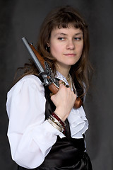 Image showing Girl - pirate with ancient pistol in hand