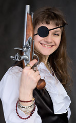 Image showing Girl - pirate with pistol in hand and eye patch