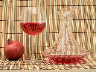Image showing Glass of wine, decanter and pomegranate